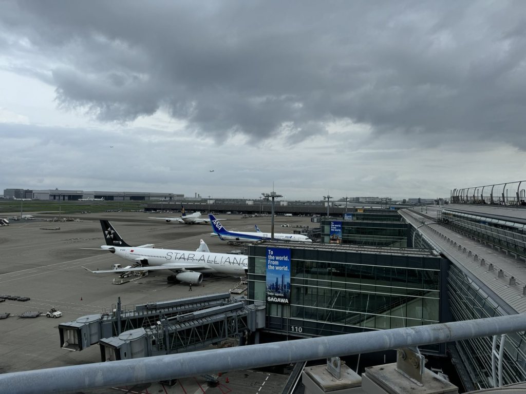 View of parked airliners and the terminal from the observation deck at Haneda Airport
