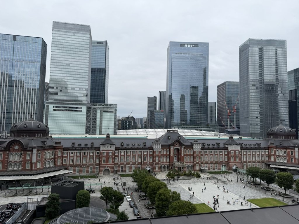 The red-brick Marunouchi building of Tokyo Station surrounded by office towers, seen from above